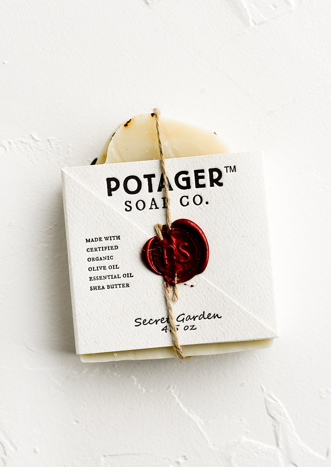 A bar soap in wax seal packaging.