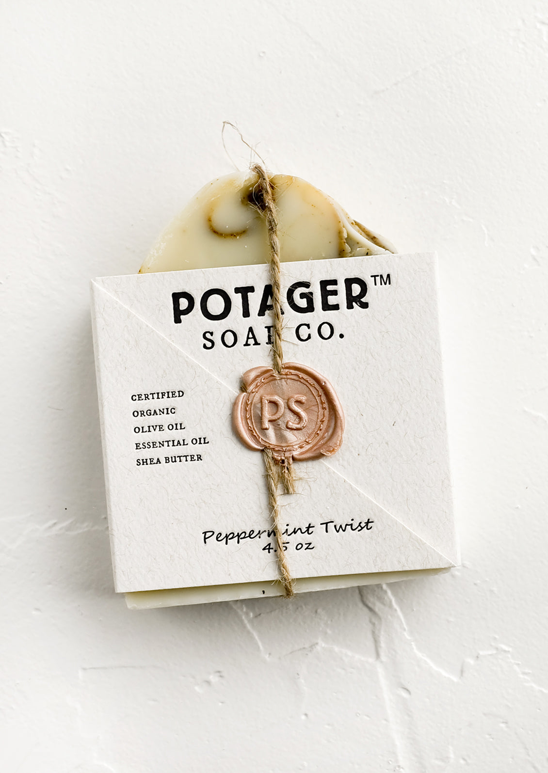 A bar soap in wax seal packaging.