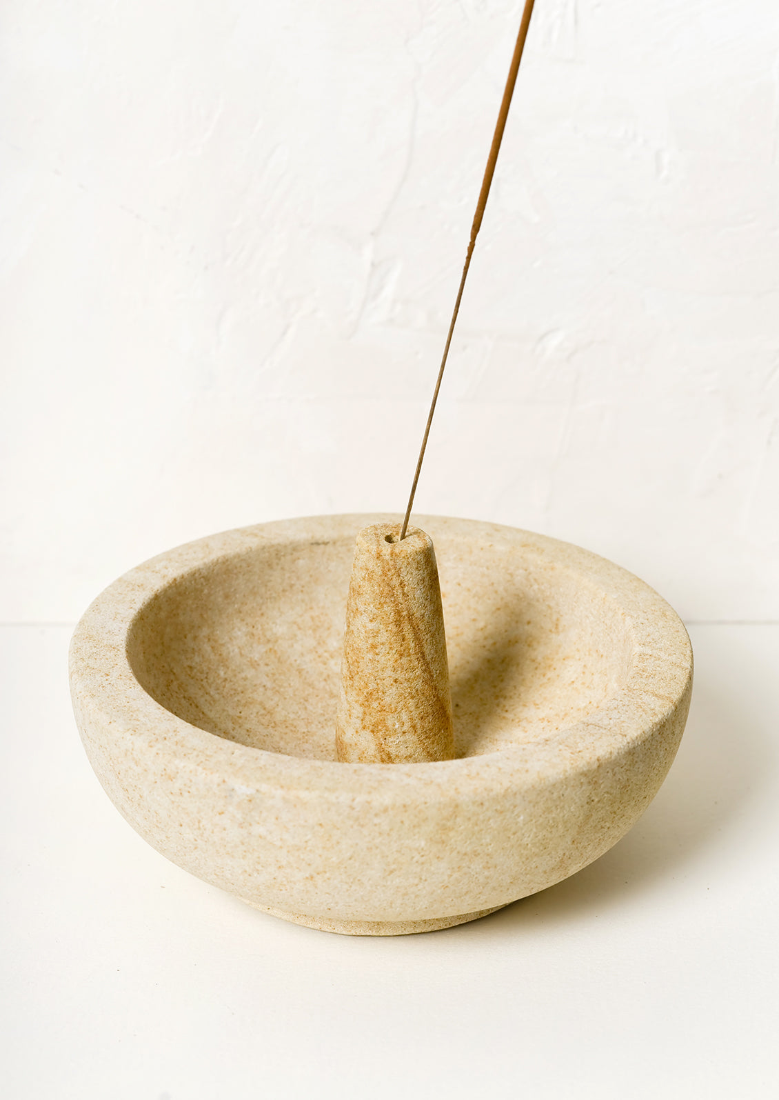 A sandstone incense burner with bowl for stick incense.
