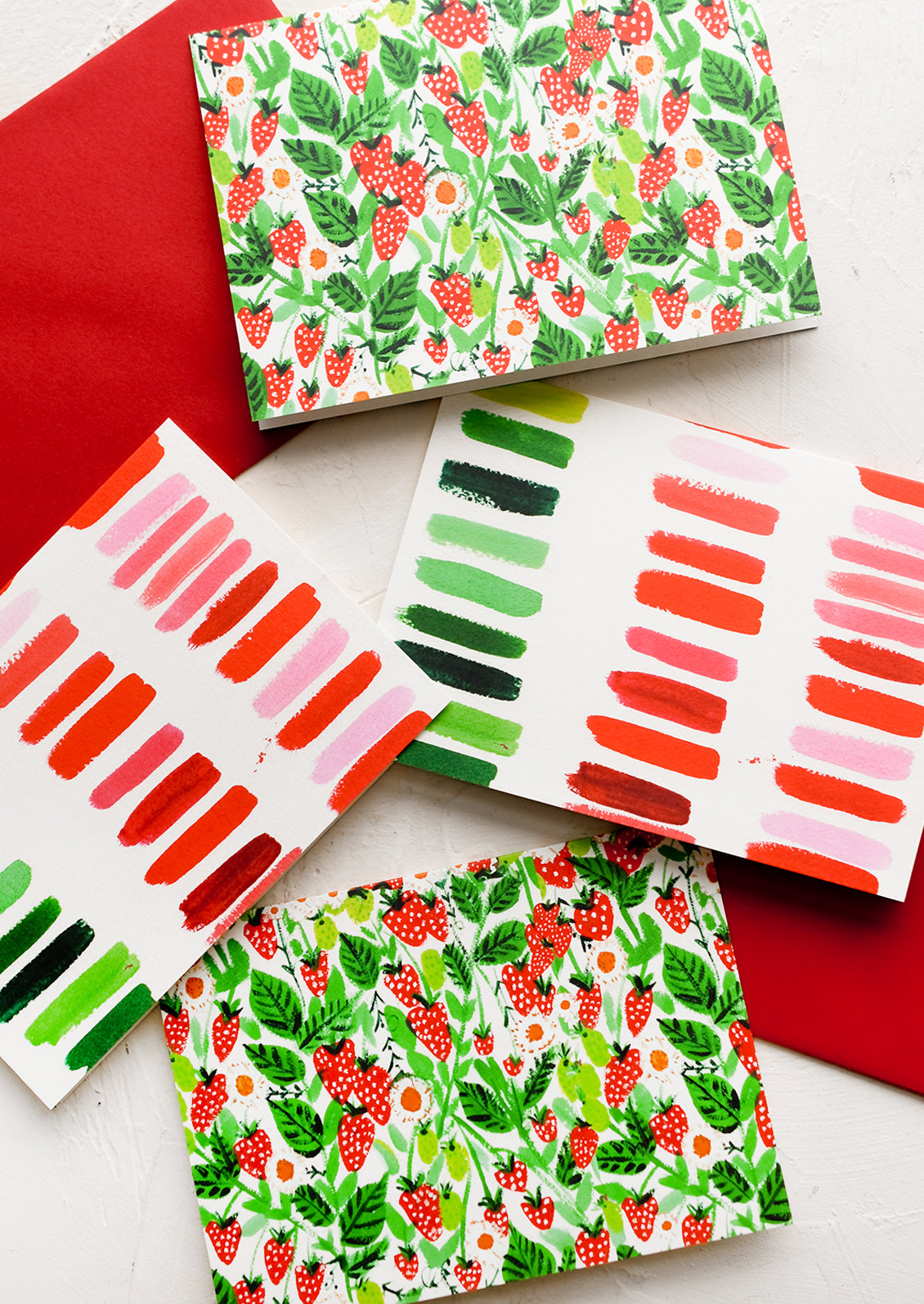 A set of cards with strawberry and brushstroke prints.