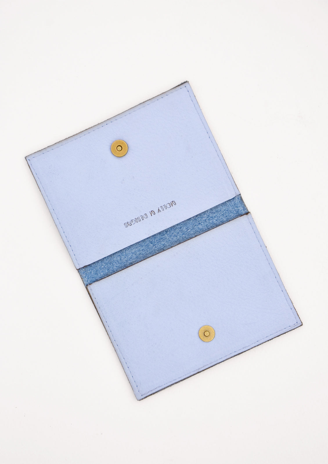 Slim blue leather wallet with two interior slip pockets that folds closed with a snap, shown open in 